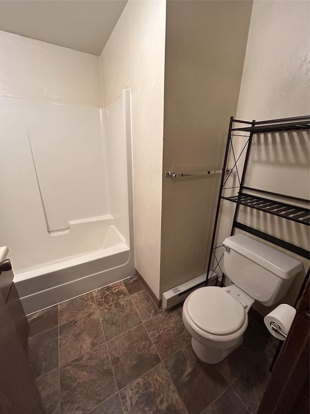 bathroom with tub / shower combination, baseboard heating, and toilet