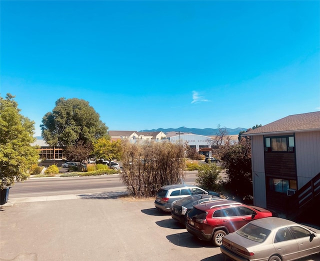 view of vehicle parking featuring a mountain view