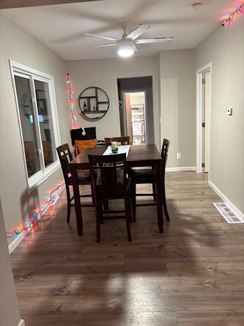 dining space featuring ceiling fan and dark hardwood / wood-style floors