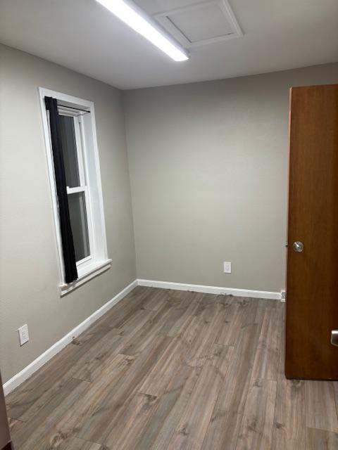 empty room with wood-type flooring