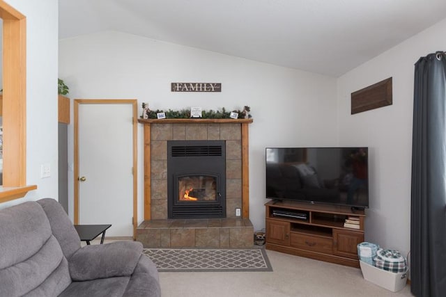 carpeted living room with lofted ceiling and a fireplace