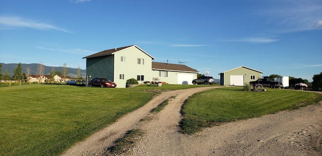 view of side of property with a mountain view and a lawn