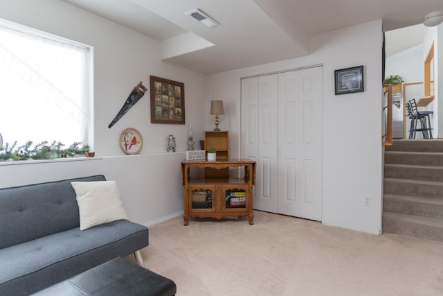 living area featuring light colored carpet