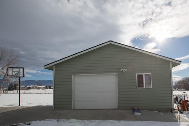 snow covered garage with a mountain view