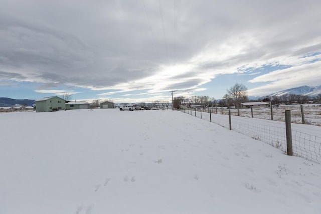 snowy yard with a mountain view