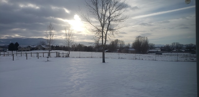 yard covered in snow with a mountain view