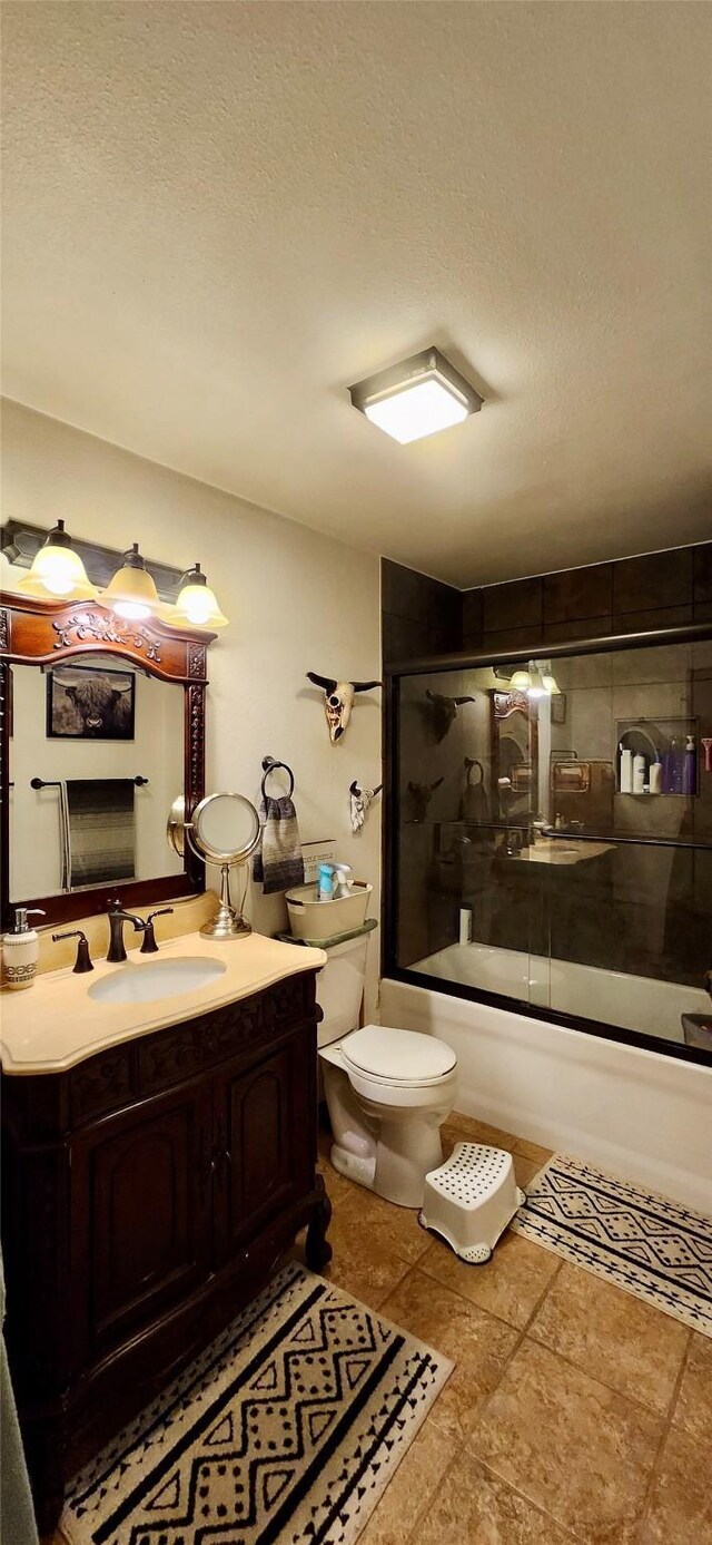 full bathroom with vanity, toilet, enclosed tub / shower combo, and a textured ceiling