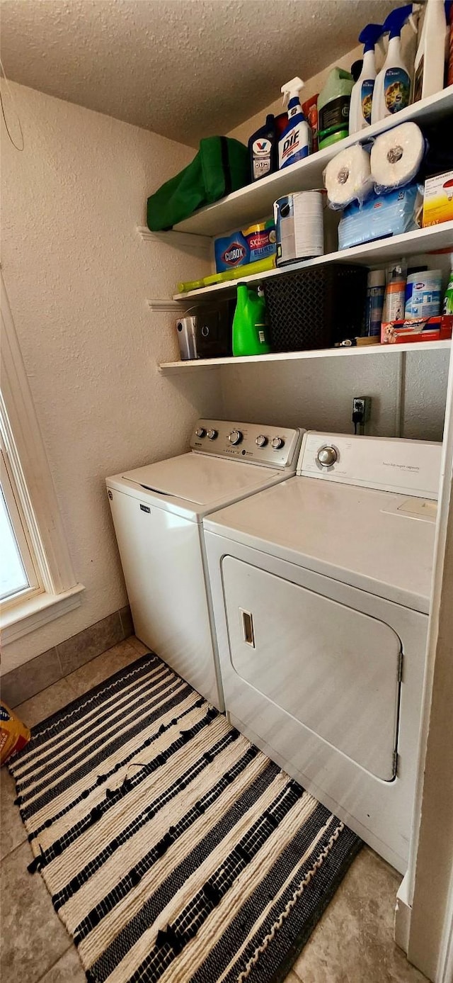 washroom featuring separate washer and dryer and light tile patterned floors