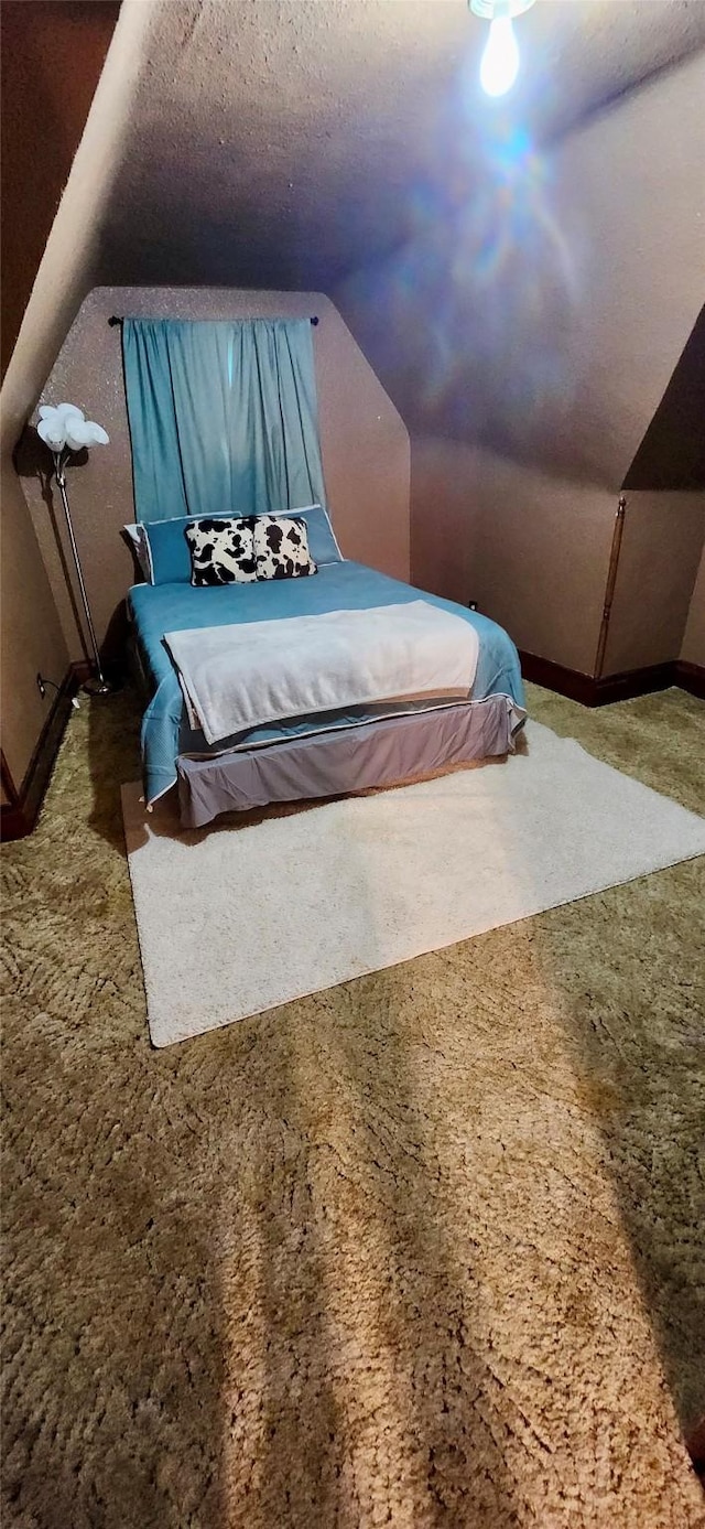 bedroom featuring a textured ceiling and lofted ceiling