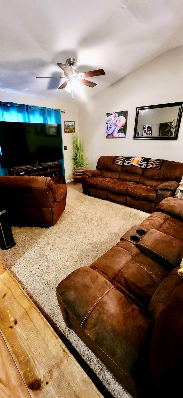 carpeted living room featuring ceiling fan