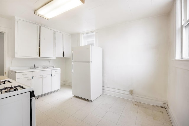 333 N 2nd St W, Missoula, MT 59802 - kitchen featuring white appliances, white cabinetry, light countertops, and baseboards