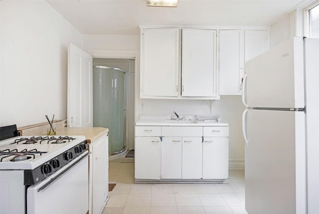 333 N 2nd St W, Missoula, MT 59802 - kitchen with white appliances, light countertops, white cabinetry, and a sink