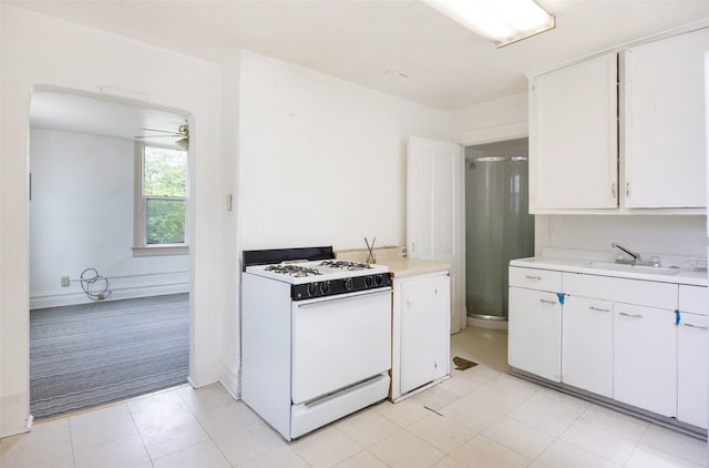 333 N 2nd St W, Missoula, MT 59802 - kitchen featuring white gas range, a sink, light countertops, and white cabinetry