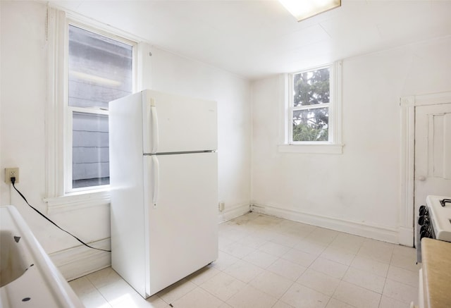 333 N 2nd St W, Missoula, MT 59802 - kitchen with freestanding refrigerator, stove, and baseboards