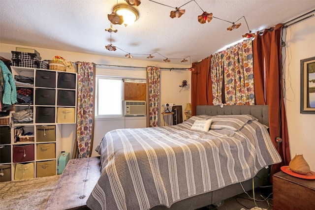 bedroom with cooling unit and a textured ceiling