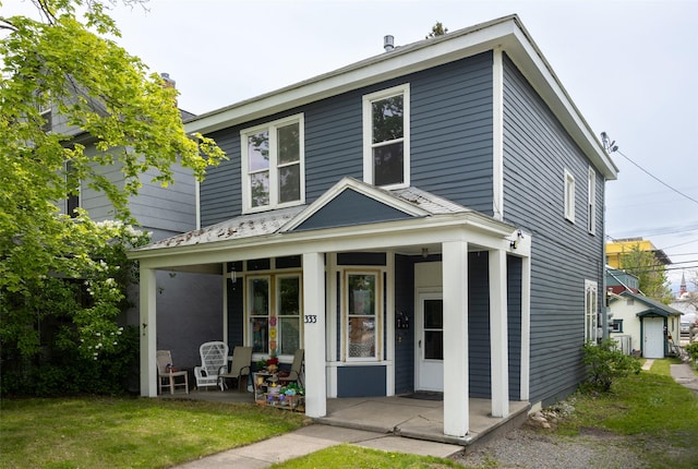 333 N 2nd St W, Missoula, MT 59802 - view of front facade with a porch, a front yard, and a chimney