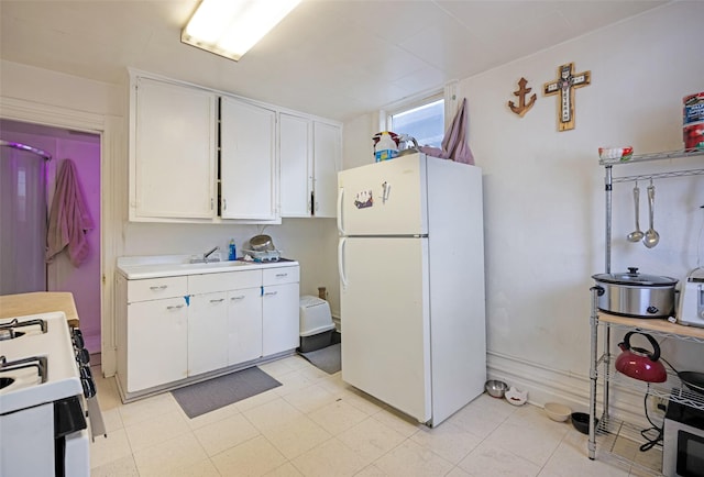 kitchen with white cabinets, white appliances, and sink