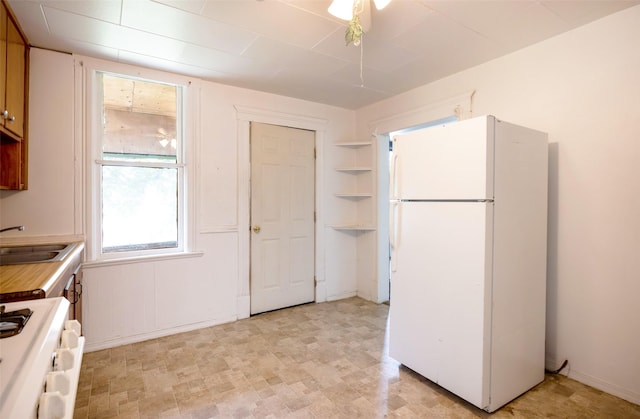 333 N 2nd St W, Missoula, MT 59802 - kitchen featuring freestanding refrigerator, range, a sink, light countertops, and baseboards