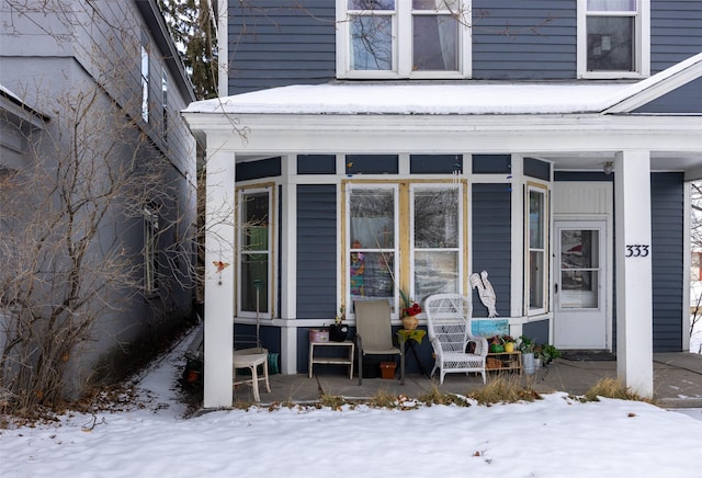 view of snow covered property entrance