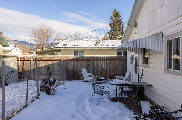 yard covered in snow with a mountain view