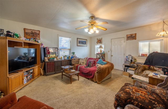 carpeted living room featuring ceiling fan, a healthy amount of sunlight, and a textured ceiling