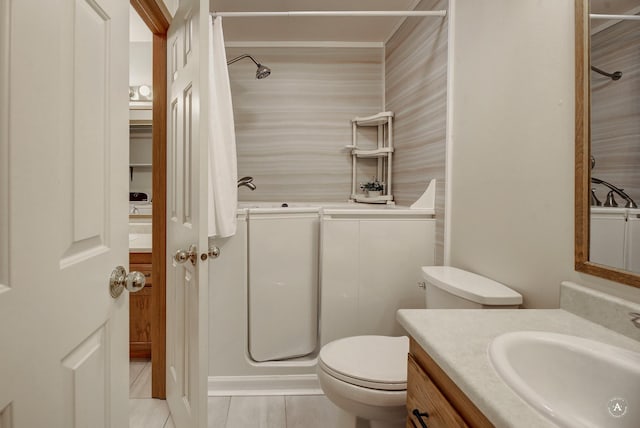 bathroom with vanity, toilet, a shower, and tile patterned flooring