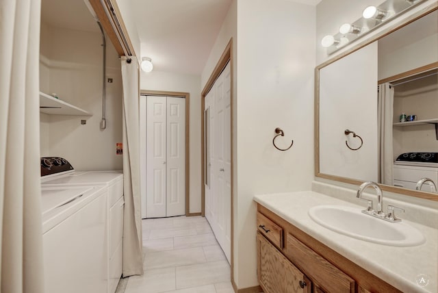 bathroom with separate washer and dryer, tile patterned floors, and vanity