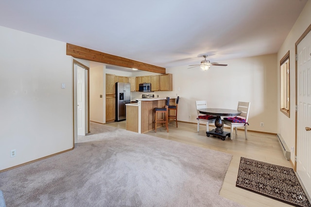 interior space featuring ceiling fan, a baseboard heating unit, and beamed ceiling