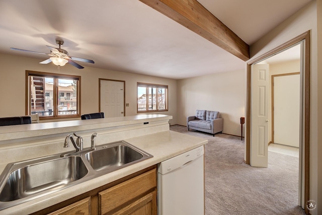 kitchen featuring light carpet, dishwasher, ceiling fan, sink, and beamed ceiling