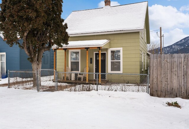 view of front facade featuring a mountain view and covered porch