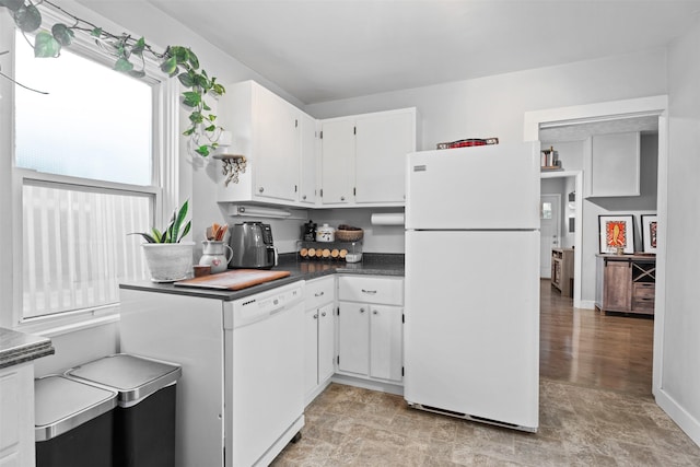 kitchen featuring white cabinets and white appliances