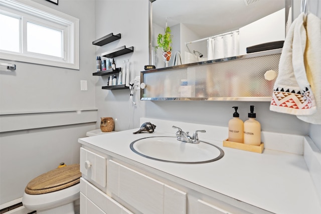 bathroom with vanity, a baseboard heating unit, toilet, and walk in shower