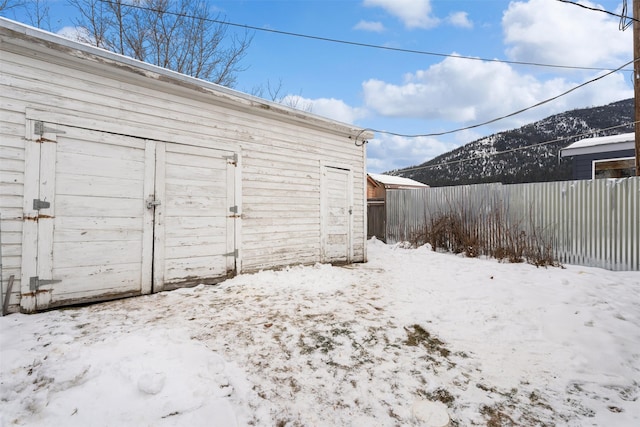 snow covered structure with a mountain view