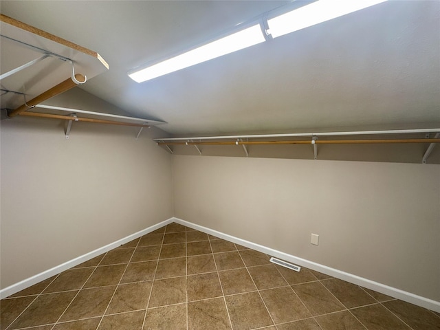 walk in closet with lofted ceiling