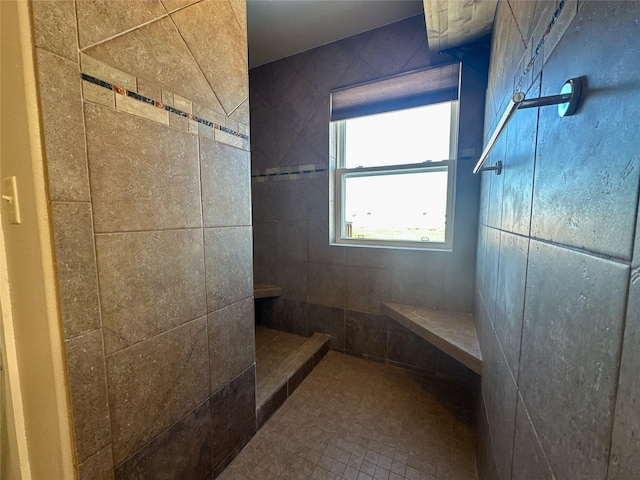 bathroom with a tile shower