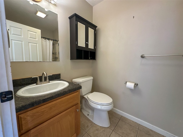 bathroom featuring vanity, toilet, and tile patterned floors