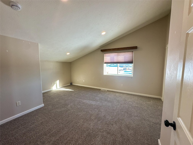 bonus room with carpet, a textured ceiling, and lofted ceiling