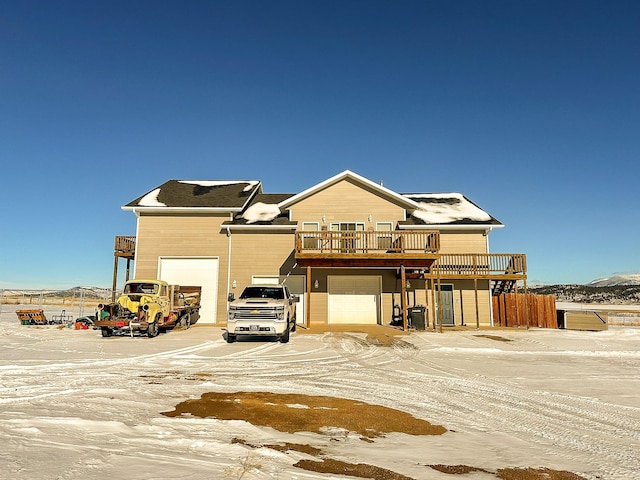 view of front of home featuring a garage and a wooden deck