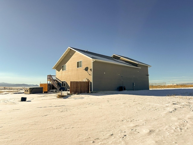 back of property with a hot tub