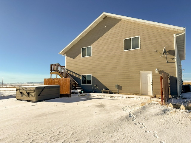 rear view of house with a hot tub