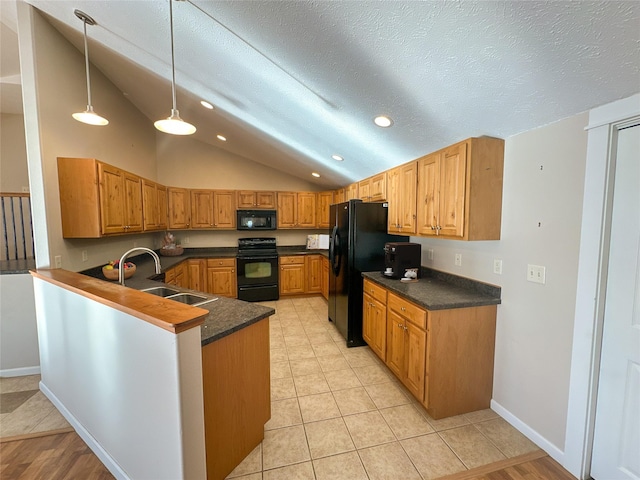 kitchen with black appliances, a textured ceiling, hanging light fixtures, sink, and kitchen peninsula