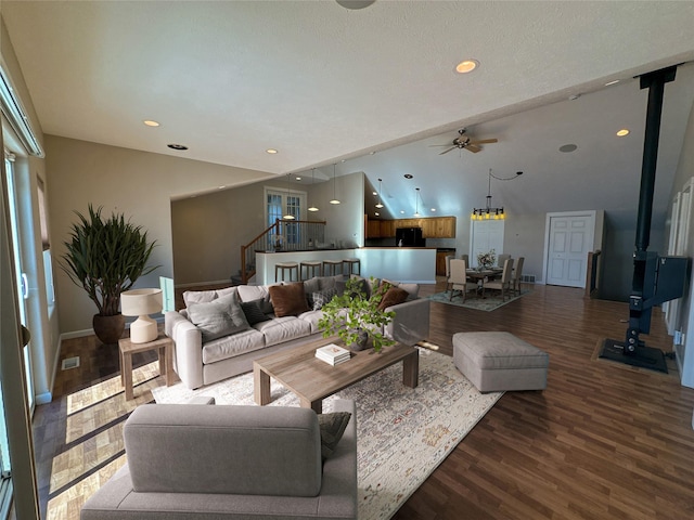 living room with hardwood / wood-style flooring, a wood stove, and ceiling fan