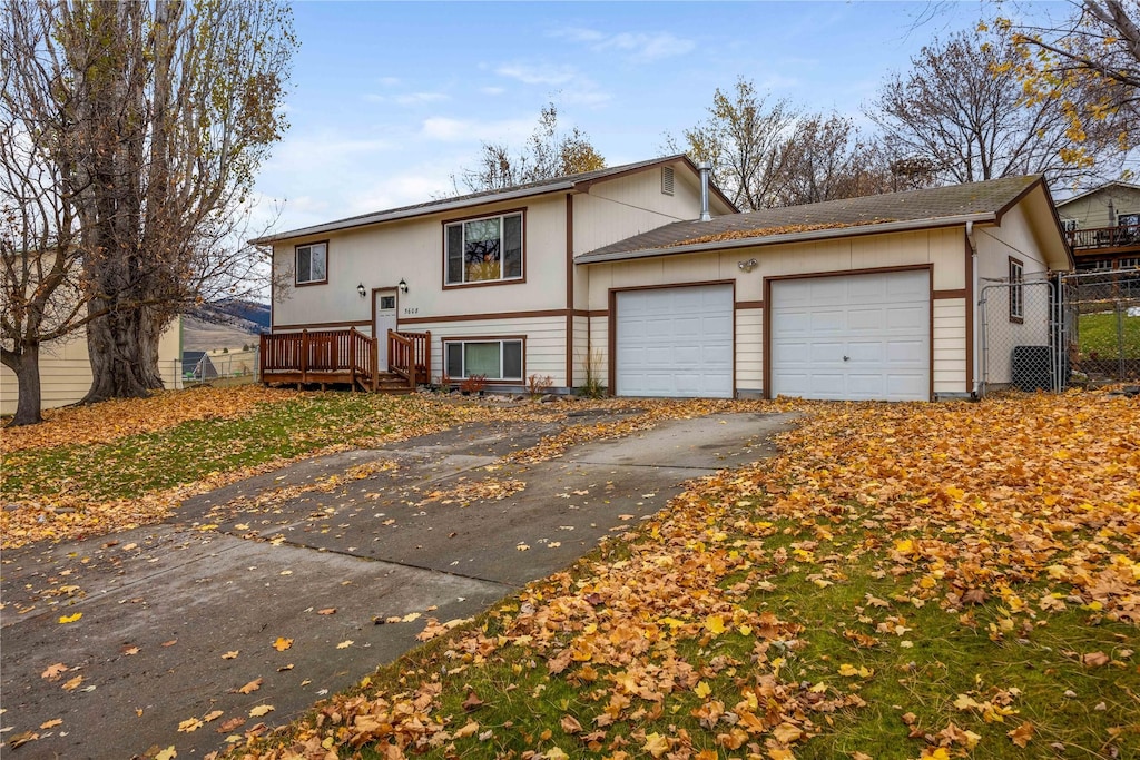 view of front of home with a garage and a wooden deck