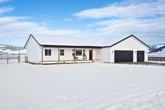 view of front facade featuring a garage and a mountain view