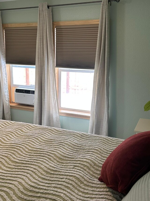 unfurnished bedroom featuring ceiling fan, ensuite bathroom, light colored carpet, and a walk in closet