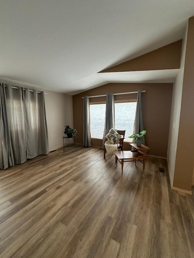 sitting room featuring lofted ceiling and hardwood / wood-style floors