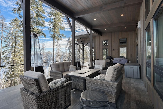 snow covered back of property featuring a mountain view