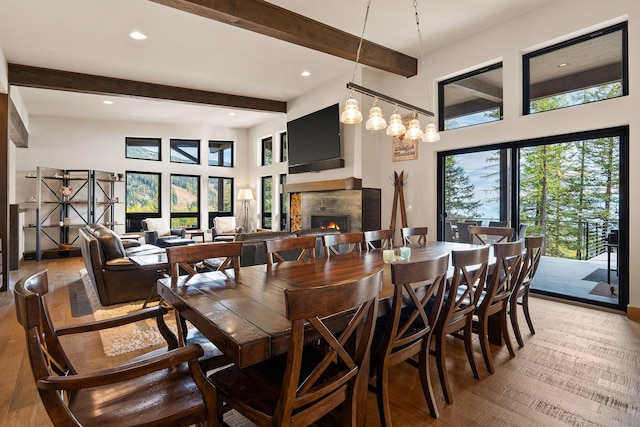 dining area with hardwood / wood-style flooring and beamed ceiling