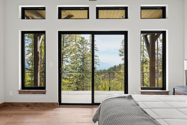 bedroom featuring hardwood / wood-style floors and access to outside