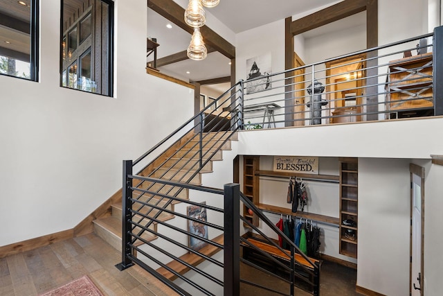 staircase with hardwood / wood-style flooring